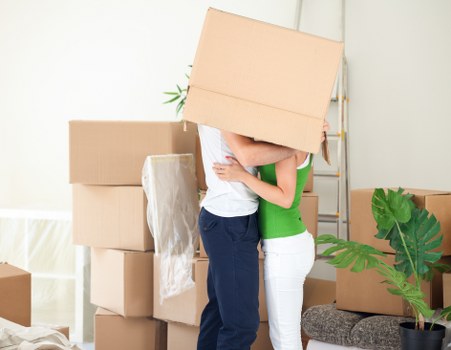 Moving team handling boxes and furniture near Isle of Dogs