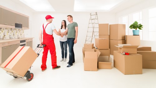 Removal crew loading items with care for a flat move in Isle of Dogs