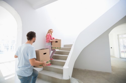 Local moving team handling access and loading near riverside apartments