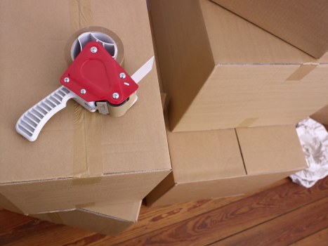 Movers handling desks and office furniture during a business relocation
