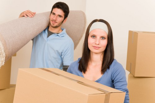 Moving helpers carrying boxes and household items in East London