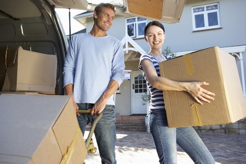 Packed household boxes and furniture ready for a flat move in Isle of Dogs